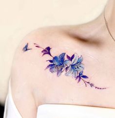 a woman's shoulder with blue flowers on it