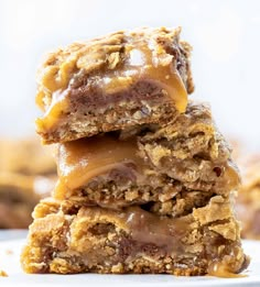 three pieces of chocolate caramel oatmeal bars stacked on top of each other