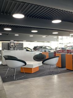 the interior of a car showroom with modern furniture