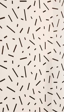 a white wall with black sprinkles on it