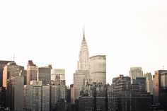 a city skyline with tall buildings in the foreground