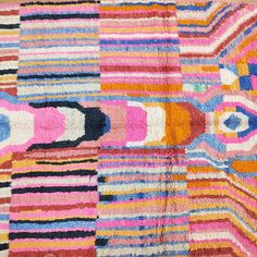 a multicolored patchwork rug with many different patterns