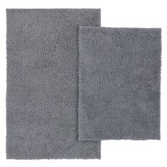 two gray rugs on white background with one in the middle and one in the back