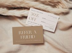 a pair of coupons sitting on top of a bed next to a fur coat