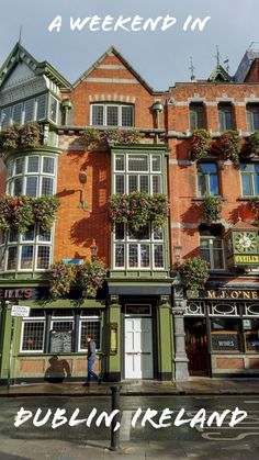 the front of a pub in ireland with flowers growing on it's windows and doors