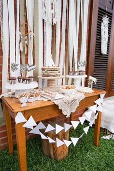 a table topped with cakes and cupcakes on top of a wooden table