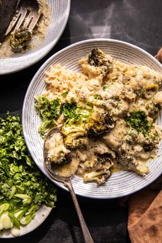 two plates filled with food next to some broccoli