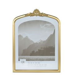 an ornate gold frame with mountains in the background