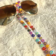 This handmade colorful flower eyeglasses chain is painstakingly hand-stitched with the finest quality glass seed beads. Thanks to the light beaded daisy chain necklace that you can use in all seasons, your glasses will not be lost. Lenght 80 cm 31,5 in                                                                                                                                                           Guaranteed to receive all compliments thanks to the eyeglasses holder that adapts to all your Cottagecore Accessories, Glasses Necklace, Beaded Sunglasses, Chain Sunglasses, Eyewear Chain, Eyeglass Necklace, Glasses Chains, Sunglasses Chain, Daisy Necklace