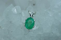 This is a beautiful and nicely sized natural Bazil Emerald set in Sterling Silver. This stone has the perfect green color that many look for in Emeralds and although it has visible inclusions which is very common with Emeralds it also has a nice luster, you will not be disappointed!! Emeralds are the birthstone for May! This nicely sized 8mm X 6mm oval Emerald weighs 1.200 cts and will go great with most styles or occasions. The size of these pendant is the perfect size for just about anyone! Ch Oval Green Natural Gemstones, Green Oval Natural Gemstones, Handmade Green Emerald Gemstones, Green Emerald Gemstones With Natural Stones, Faceted Oval Green Gemstones, Natural Green Emerald Gemstones, Emerald Set, Emerald Pendant, Box Chain