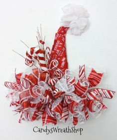 a red and white candy cane wreath is hanging on the wall