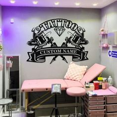 the tattoo parlor is decorated with pink furniture and purple lighting, as well as a wall decal that says tattoo custom name