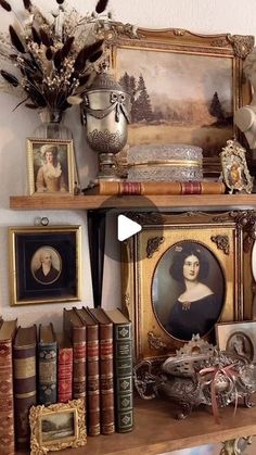 there is a shelf with many books and pictures on it, including an antique portrait