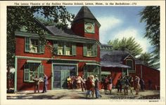 an old postcard shows people standing in front of a red building with a clock tower