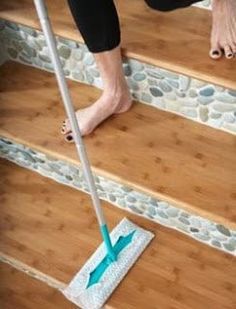 a person is cleaning the stairs with a mop