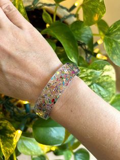 "This is just a fun, glittery, one-of-a-kind bracelet. I mixed a bunch of different glitters together to make something colorful and different. Inside diameter of bangle measures 2.5\". Bracelet is 17mm wide. Please measure your wrist to make sure this will be a good fit. MADE IN USA." Handmade Bangle Bracelets, Snowflake Jewelry, Glitter Jewelry, Tube Bracelet, Winter Earrings, Resin Bangles, Resin Bracelet, Winter Jewelry, Snowflake Earrings