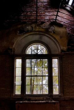 an open window in a brick wall next to a wooden door