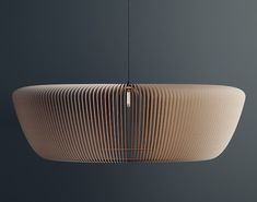 a light that is hanging from the ceiling in a room with gray walls and flooring