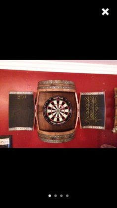 there is a dart in the middle of a wooden barrel and darts are on the wall