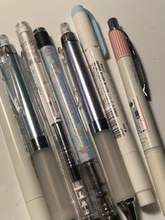 several pens lined up on top of each other