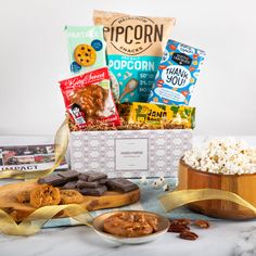 the snack box is filled with snacks, cookies and crackers as well as popcorn