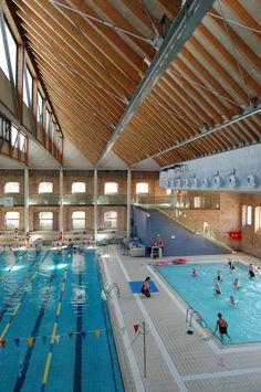 an indoor swimming pool with people in it