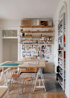 a craft room with lots of tools on the wall