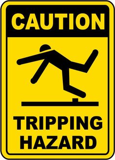 a yellow caution sign with the words tripping hazard