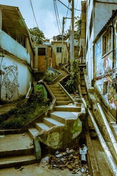 an old run down alley with graffiti on the walls and steps leading up to it