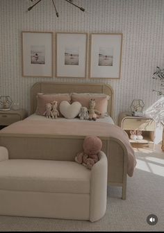 there is a bed with two teddy bears on the headboard and pillows in front of it