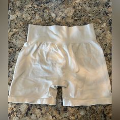 a pair of white shorts sitting on top of a counter