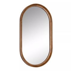 an oval wooden mirror hanging on the wall