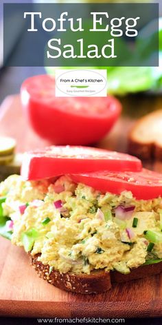 an egg salad sandwich with tomatoes and lettuce