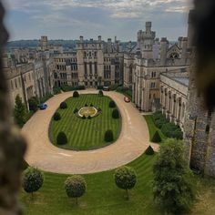 an aerial view of a large building with a circular garden in the middle