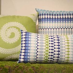 three pillows sitting on top of a bed next to each other