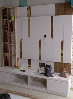 a room with white cabinets and shelves in it