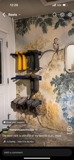 the wallpaper in this room is painted with birds and trees, while shelves are decorated with yellow vases