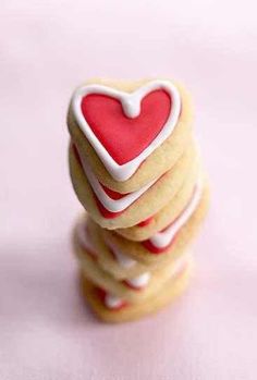 three cookies stacked on top of each other with a heart shaped cookie in the middle