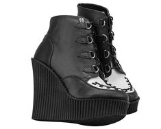 With these two-tone T.U.K. Creeper Wedge Booties on your feet, you'll be everyone's fun ADD distraction. The black and white leather upper features petite d-ring tabs and silver metal d-rings with black laces for tying up. The black interlace on the front gives these wedges the classic creeper look. The bootie upper is about 4 ½ inches high, finishing right above the ankle. The ridged PU sole is lightweight and the height ranges from about 5 1/4 inches in the back to 1 1/4 inches in the front. T Punk Leather Wedge Heel Boots, Punk Style Leather Boots With Wedge Heel, Punk Leather Boots With Wedge Heel, Alternative Style Leather Wedge Boots With Round Toe, Leather Wedge Boots With Round Toe For Alternative Fashion, Alternative Leather Wedge Boots With Round Toe, Edgy Leather Wedge Boots For Alternative Fashion, Leather Wedge Boots For Alternative Fashion, Edgy Platform Boots With Rubber Sole