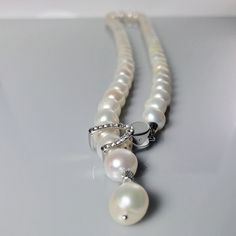 This unique Pearl Necklace at M by Margaret Quon is handmade from Freshwater Pearl and CZ Silver Shortener Cap, Rhodium Plated Knot and Sterling Silver Bell.  Every woman should own a string of pearls. The epitome of femininity, pearls are sublimely beautiful and as unique as you are. Every pearl is individual with its own distinctive character; and because pearl is organic it reacts with the natural oils in your skin, giving it that gorgeous iridescence. Timelessly connecting you with that most Modern Pearl Necklace, Unique Pearl Necklace, April Birthstone Necklace, String Of Pearls, Silver Bells, Agate Earrings, April Birthstone, Modern Necklaces, Unique Necklace