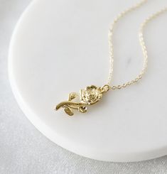 "Beautiful and lovely gold rose flower pendant necklace. Made of dainty gold plated rose flower pendant with a skinny gold plated brass chain. Soft and simple. Great for gift, everyday or special occasion. Your item will ship in a gift box. Please feel free to contact me if you have any question. ♥ Length 15\" - 20\" chain ♥ Pendant approx. 3/8\" x 7/8\" ♥ Gold plated over brass ♥ See more Rudiana Accessories Rudiana.etsy.com" Everyday Rose Gold Flower Pendant Necklace, Delicate Rose Gold Pendant Flower Necklace, Dainty Rose Design Flower-shaped Necklace, Gold Charm Necklace With Rose Flower Pendant, Golden Rose Necklace, Gold Rose Flower, Flower Pendant Necklace, Rose Necklace, Necklace Rose