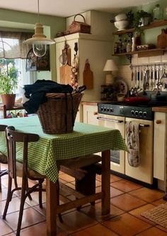 a kitchen with an oven, stove and table in it