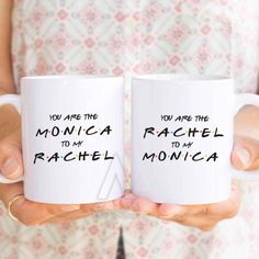 two white coffee mugs with the words mother of the groom and bride printed on them