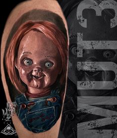 a tattoo with a creepy doll on it's arm and the word chucky written in