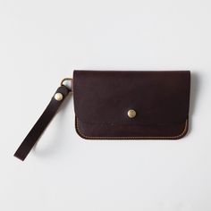 + DIMENSIONS Height: 5.25 inches Width: 8.5 inches Wristlet strap length: 5.5 inches + WRISTLET CLUTCH DETAILS Keep your friends close – and your daily essentials closer. When you need a sleek way to carry the basic necessities, you can't go wrong with KMM & Co.'s leather wristlet clutch. Handmade in the same full-grain leathers as your favorite tote, the wristlet has space for your cards, keys, and phone. Each wristlet clutch features an undivided main compartment, plus a rear pocket that you c Leather Wristlet With Removable Pouch For Daily Use, Leather Rectangular Wristlet With Removable Pouch, Leather Coin Purse With Smooth Grain For Everyday Use, Leather Travel Wristlet Pouch, Brown Clutch With Coin Pocket For Everyday Use, Everyday Use Smooth Grain Pouch Wallet, Leather Pouch Wristlet As Gift, Leather Rectangular Wristlet For Daily Use, Daily Use Leather Rectangular Wristlet