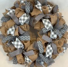 a wreath made out of burlocks and ribbon