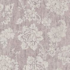 an area rug with flowers and leaves on the ground, in grey tones that are slightly shabby