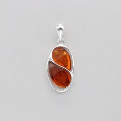 These is a beautiful Sterling Silver Pendant with Amber. The pendant is made out of solid 925 Silver and there is no nickel or other substances causing most allergies. This makes the pendant hypo allergenic. Size of the Pendant in total - with the bail 3.7 x 1.5 cm or  1.46 x 0.59 inch Please note: Our jewelry is photographed close up to show detail and may appear larger than they are. We are happy to help with any questions. We use a dime coin as size reference on one of the pictures. You will Sterling Silver Jewelry With Shiny Finish And Oval Shape, Oval Sterling Silver Jewelry With Shiny Finish, Classic Sterling Silver Oblong Jewelry, Polished Oblong Sterling Silver Jewelry, Oblong Sterling Silver Jewelry With Polished Finish, Crystal Healing Stones, Oval Pendant, Baltic Amber, Healing Stones