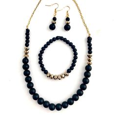 A very pretty jewelry set. Black onyx polished stone beads with gold glass beads in a symmetrical pattern. This necklace measures about 18 inches in length, & the bracelet is beaded on clear strong elastic. The matching earrings measure just over 1.75 inches in length from top to bottom & come with earring backs. (Please contact me if you would like to add a 2-inch extension chain to the necklace). A very unique & pretty black & gold jewelry set! Gold Onyx Beaded Necklaces With Gemstone Beads, Gold Onyx Gemstone Beaded Necklaces, Gold Onyx Beaded Necklaces With Black Beads, Gold Beaded Necklace With Black Onyx Beads, Gold Onyx Beaded Necklace With Black Beads, Adjustable Onyx Beaded Necklace With Faceted Beads, Gold Jewelry Set, Symmetrical Pattern, Semiprecious Stone Jewelry