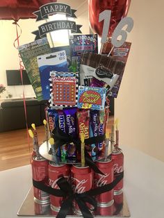 a birthday cake made out of soda cans